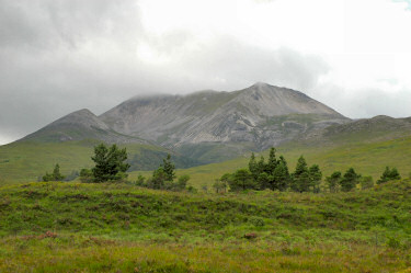 Picture of a mountain, clouds just touching the top