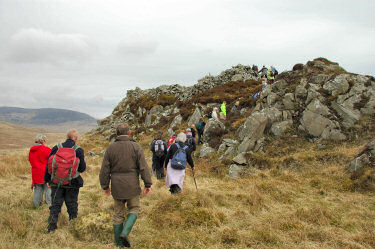 Picture of walkers climbing up the entrance to an ancient hill fort