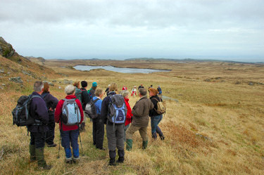 Picture of a group of walkers looking back over a loch (lake)