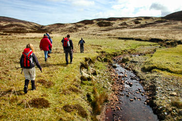 Picture of walkers walking along a burn (stream)