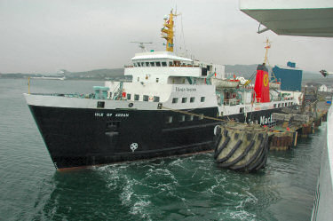 Picture of a ferry at a pier, taken from another ferry