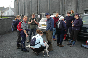 Picture of walkers standing around some cars