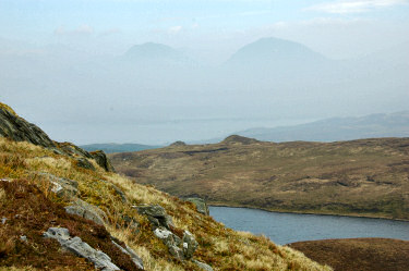 Picture of two mountains with just the summits visible in the haze