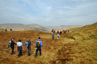 Picture of a walkers walking into a wide glen