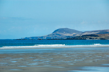 Picture of a view over a beach to hills in the background