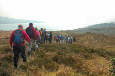 Picture of walkers above a sound, very little visibility due to haze
