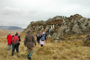 Picture of a group of walkers approaching an ancient hill fort