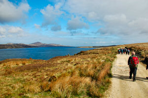 Picture of walkers next to a sound, the Sound of Islay