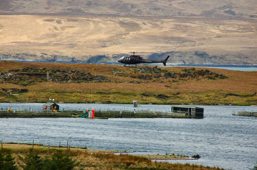 Picture of a helicopter above a fish farm