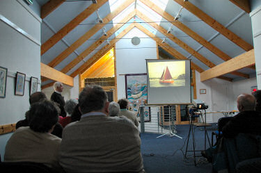 Picture of a presenter, a skiff on the overhead