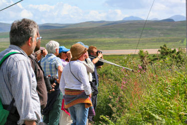 Picture of a group of people, some looking through binoculars