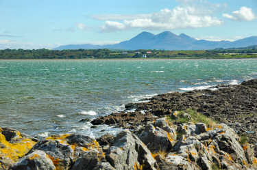 Picture of a view over a choppy sea loch with some large mountains in the distance
