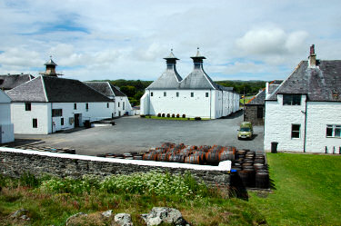 Picture of a yard at Ardbeg distillery, some empty casks stored in the yard