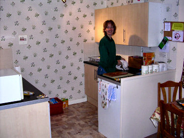 Picture of a young woman standing in a kitchen