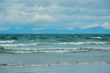 Picture of the hills of an island seen across the sea