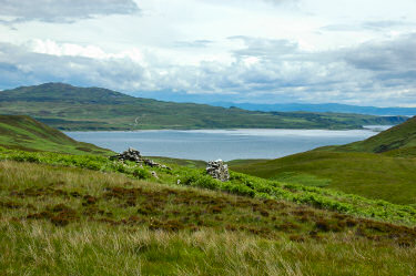 Picture of a view down a glen towards a sound between two islands