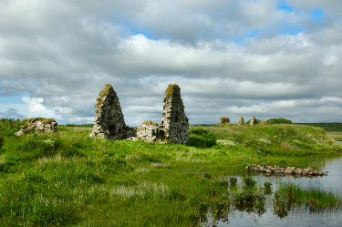 Picture of an island in a loch (lake) with the ruins of a few buildings