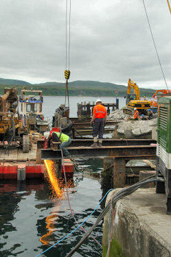 Picture of a worker with a blowtorch, creating lots of sparks