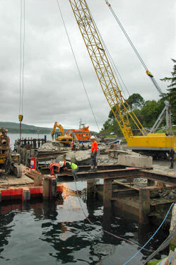 Picture of workers dismantling an old pier