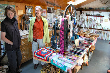 Picture of two women standing in a shop selling various handcrafted items