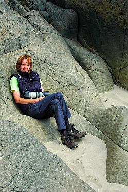Picture of a woman sitting in some rocks shaped like a comfortable chair