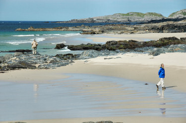 Picture of two people looking around a beach