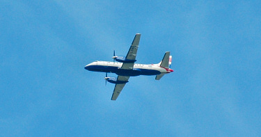Picture of a small passenger plane flying accross