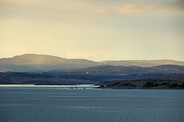 Picture of the sun breaking through over an island