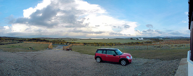 Picture of a panoramic view over a wide landscape, a sea loch on the distance