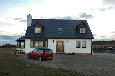 Picture of a guesthouse with a red Mini Clubman parked outside
