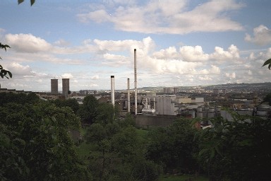 Picture of a view over a town, industrial area in the foreground