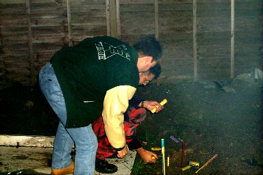 Picture of two men lighting fireworks