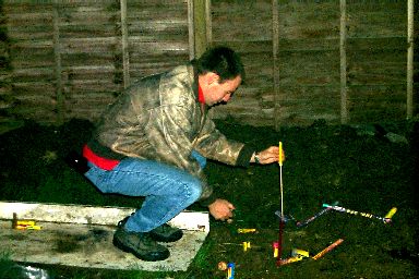 Picture of a man lighting a rocket for a firework