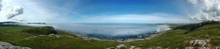 Picture of a panoramic view over sea bay with haar (sea fog) moving in