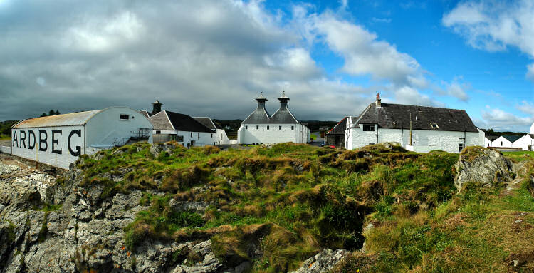 Picture of a panoramic view over a distillery (Ardbeg) in the late afternoon light