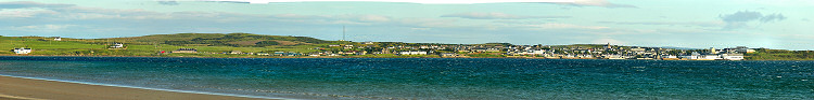 Picture of a panoramic view over a coastal village on the shore of a sea loch