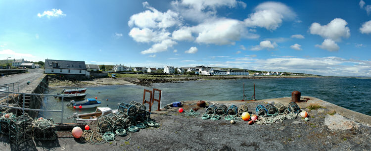 Picture of a coastal village with a distillery, seen from the pier