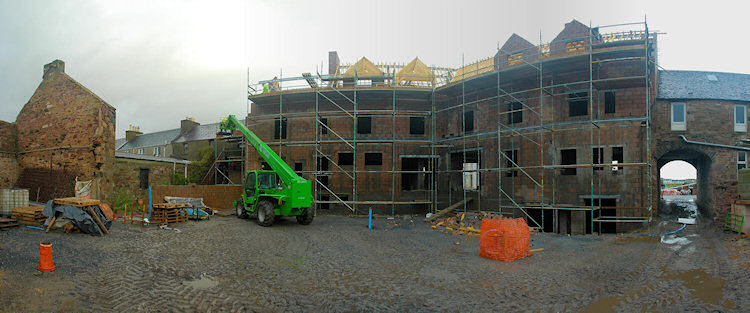 Panorama picture of the back of a building site for a hotel, the second floor is nearing completion