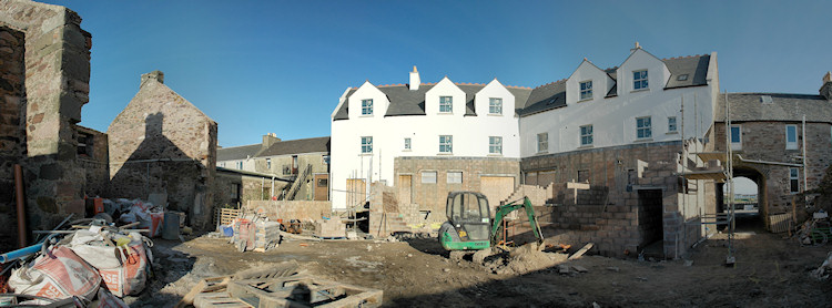 Panorama picture of the back of a building site for a hotel, the scaffolding has been removed and the walls are painted