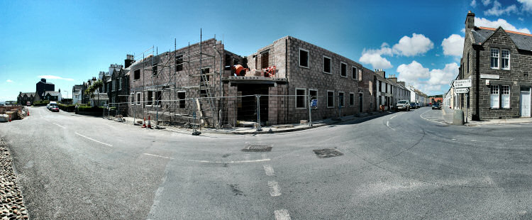 Panorama picture of a building site for a hotel, the first floor is nearing completion