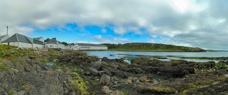 Picture of a panoramic view over a small sea loch with a distillery (Laphroaig) on the shore