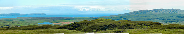 Picture of a view over a sea loch and the sea to a peninsula and another island on the other side