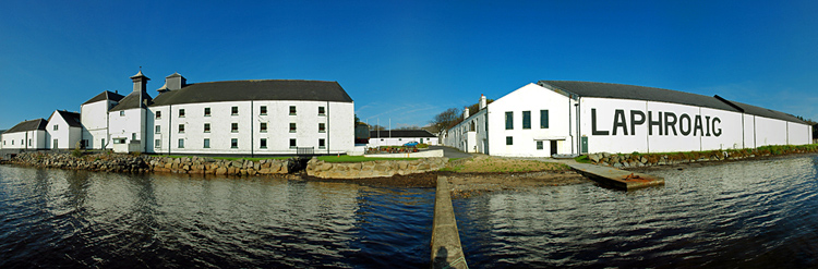 Picture of a panoramic view over a distillery on the shore of a sea loch (Laphroaig distillery at Loch Laphroaig, Isle of Islay)