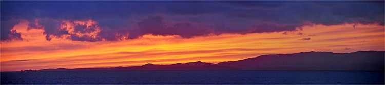 Picture of a panoramic view of a colourful sunset over an island