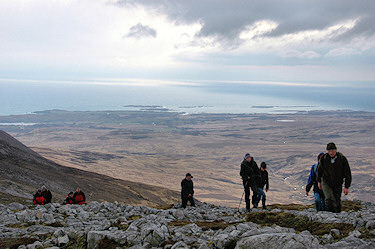 Picture of walkers approaching the summit of a high hill